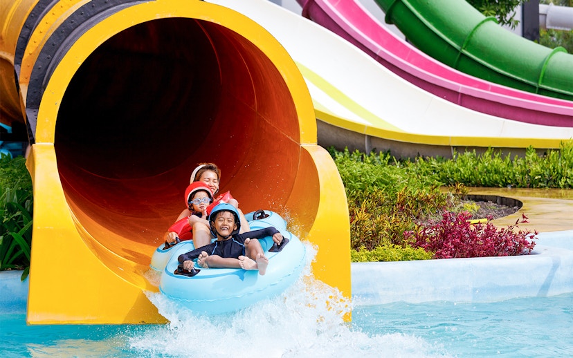 Family enjoying water slide at Yas Waterworld Abu Dhabi.