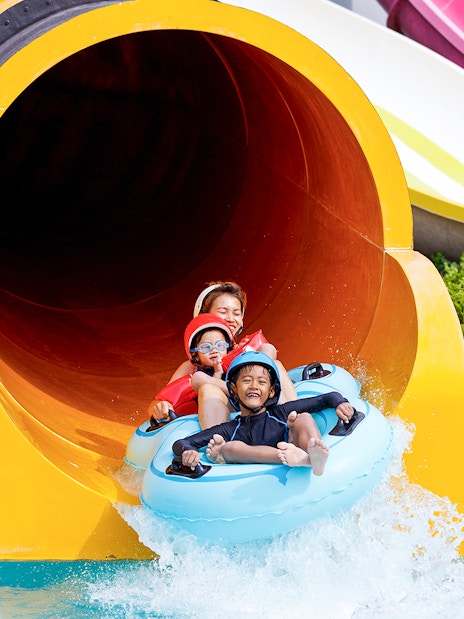 Family enjoying water slide at Yas Waterworld Abu Dhabi.