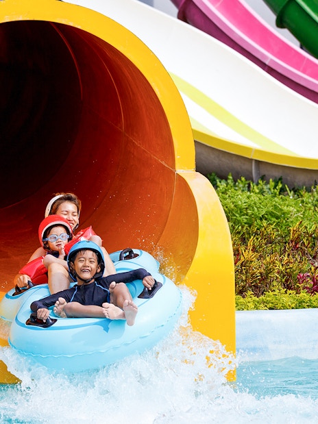Family enjoying water slide at Yas Waterworld Abu Dhabi.