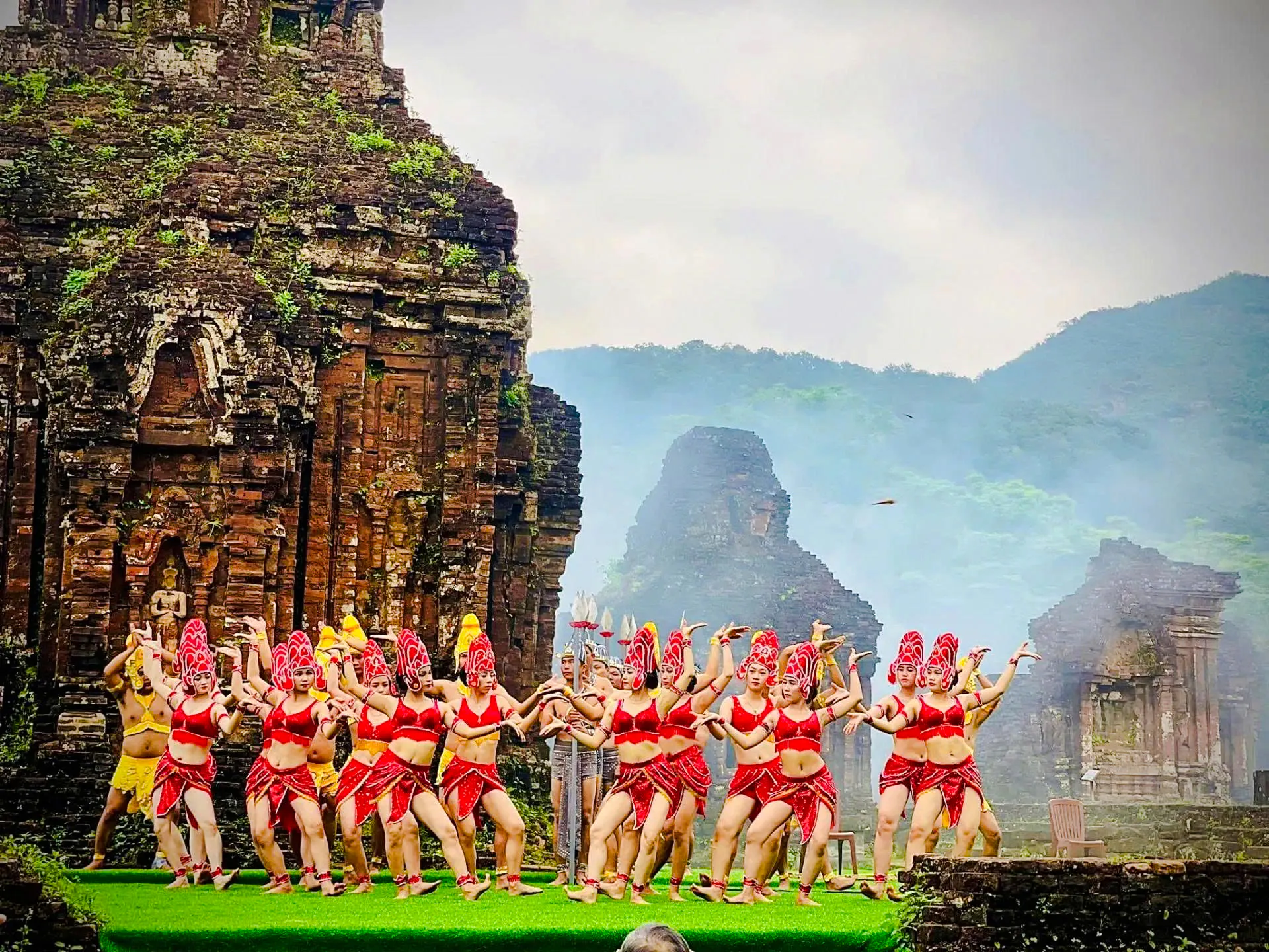 Traditional dance performance at My Son Sanctuary, Hoi An, with ancient temple ruins in the background.