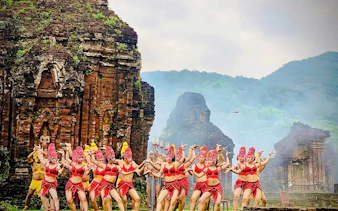Traditional dance performance at My Son Sanctuary, Hoi An, with ancient temple ruins in the background.