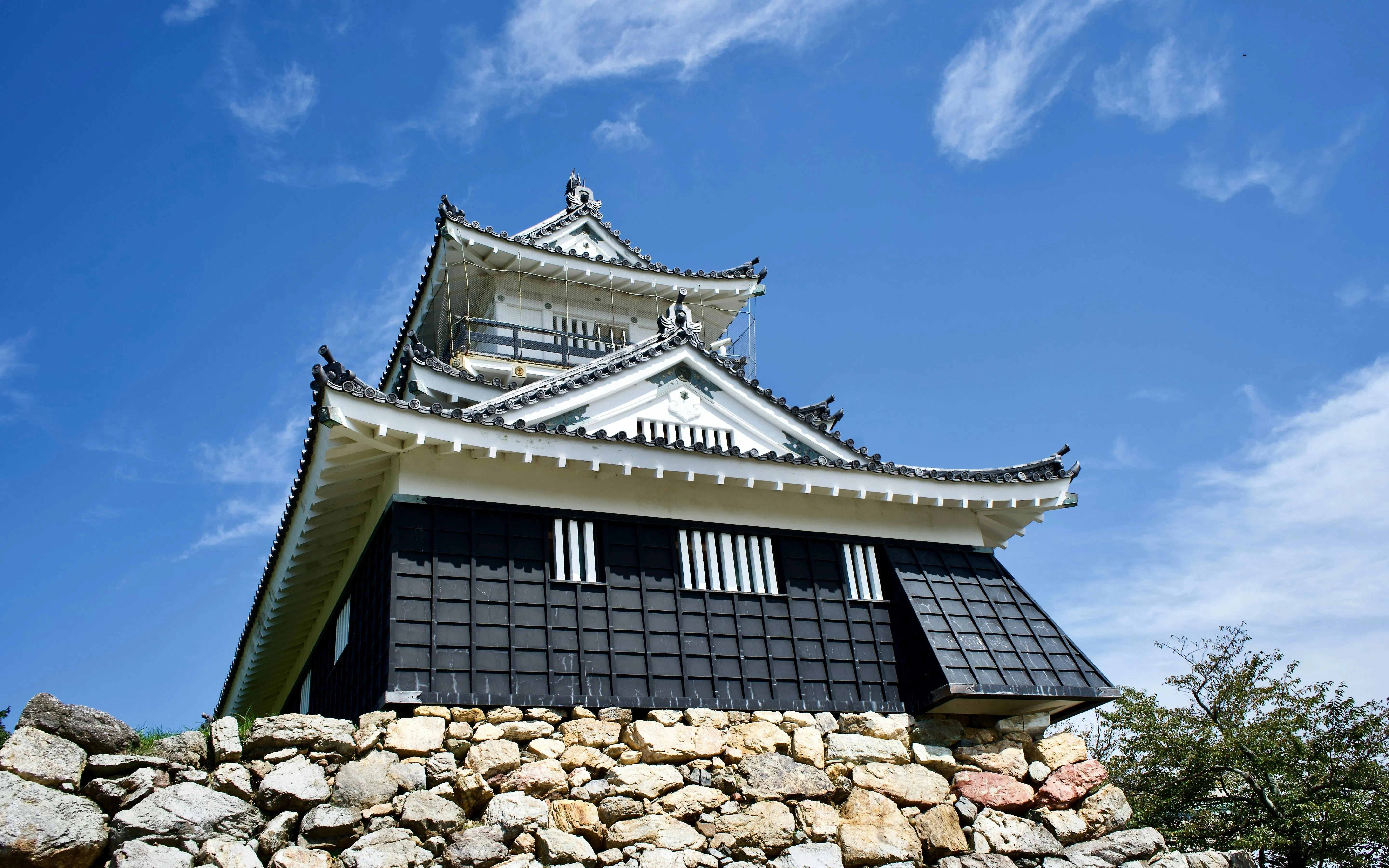Hamamatsu Castle in Japan with traditional architecture under a clear blue sky.
