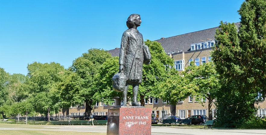 Statue of Anne Frank in a park setting, Amsterdam.