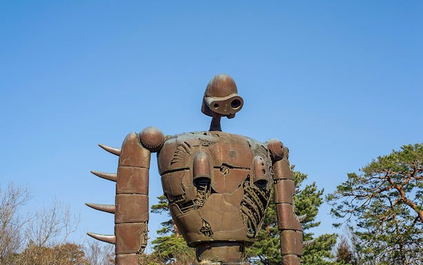 Giant robot statue at Studio Ghibli Museum, Japan, under clear blue sky.