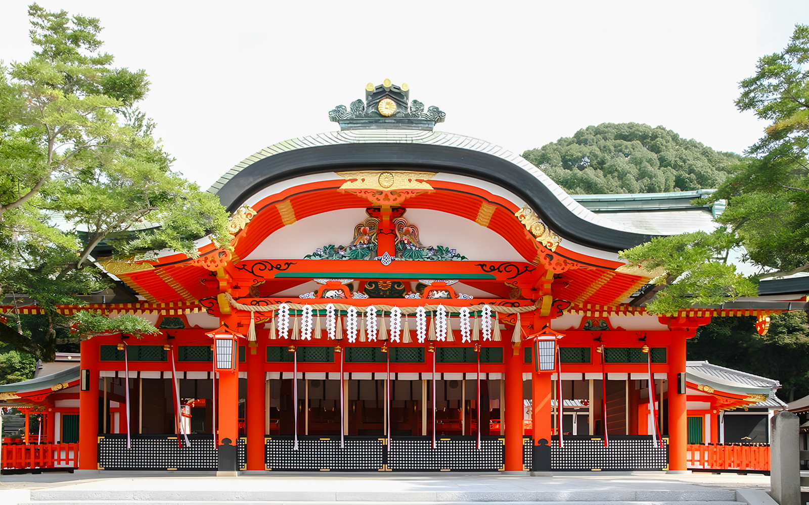 Fushimi Inari Taisha Shrine entrance with vibrant red and white architecture, Kyoto.