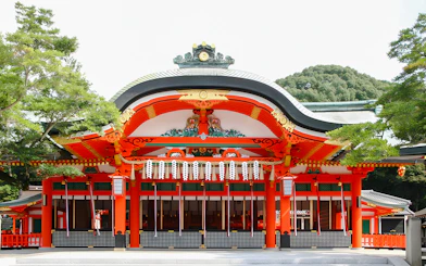 Fushimi Inari Taisha Shrine entrance with vibrant red and white architecture, Kyoto.