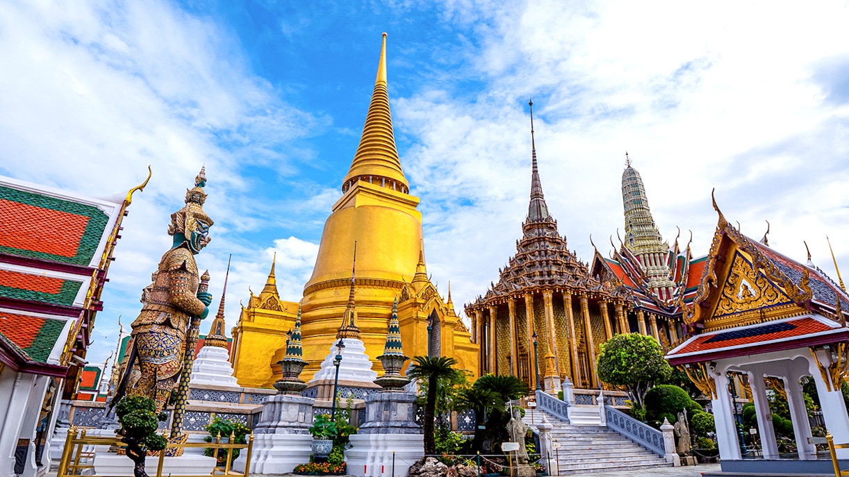 Wat Phra Kaew and Grand Palace with golden spires and ornate statues, Bangkok, Thailand.