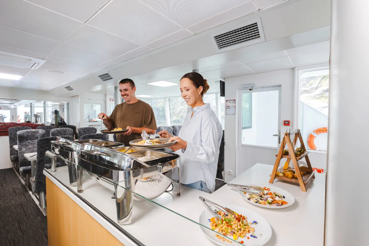 Guests enjoying buffet on Milford Sound VIP cruise from Te Anau.