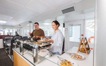 Guests enjoying buffet on Milford Sound VIP cruise from Te Anau.