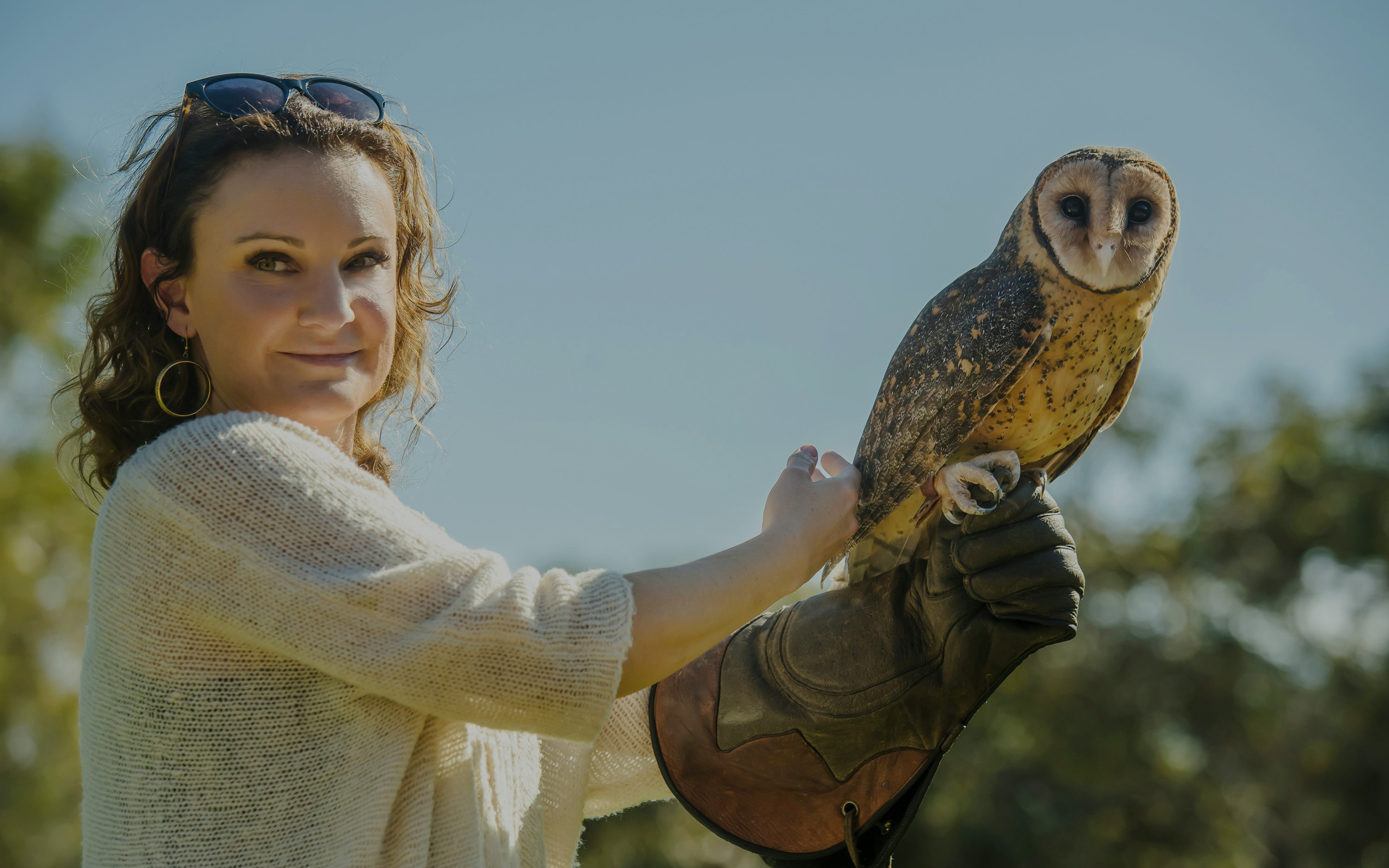 Woman holding owl at Raptor Domain, Kangaroo Island.
