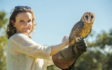 Woman holding owl at Raptor Domain, Kangaroo Island.