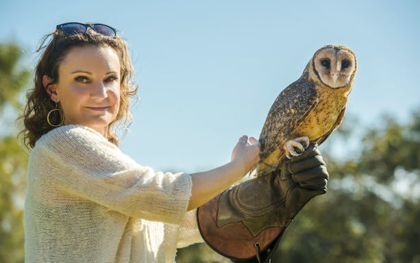 Woman holding owl at Raptor Domain, Kangaroo Island.