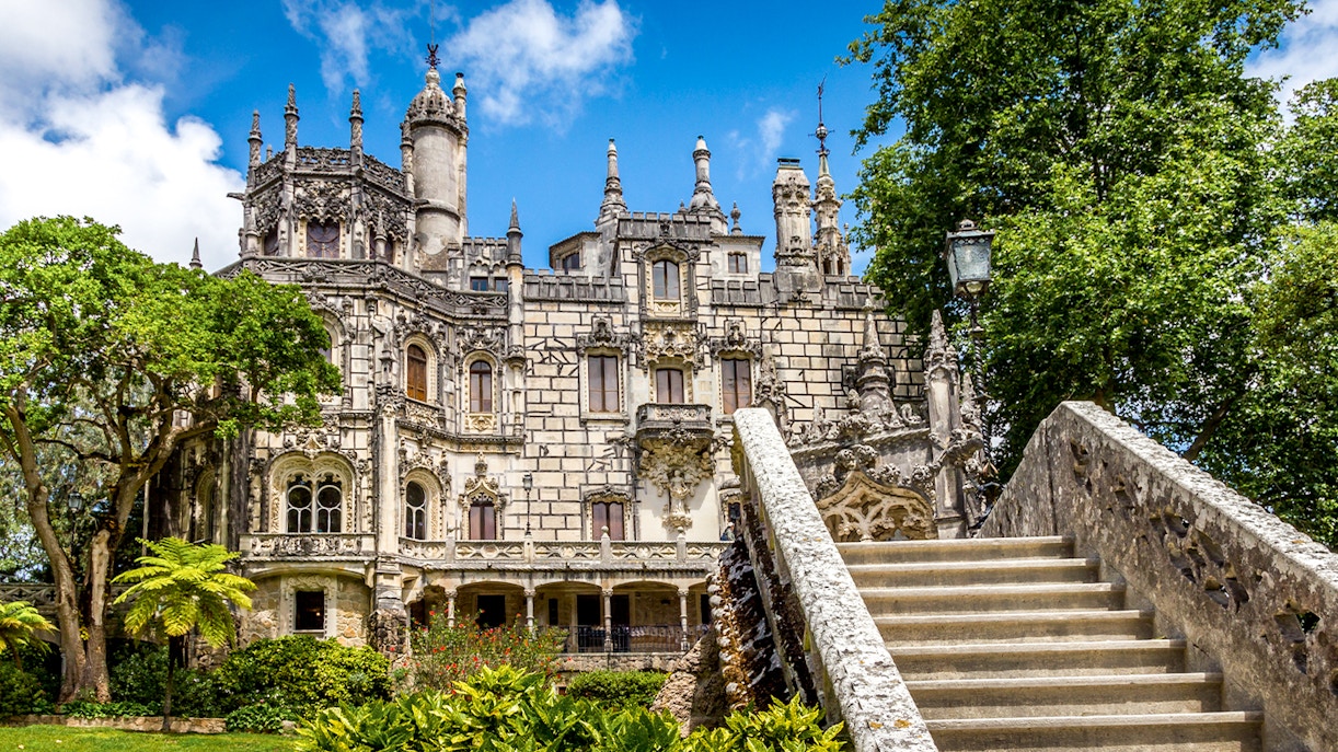 Quinta da Regaleira front view, Sintra, Portugal, showcasing Gothic architecture and lush gardens.