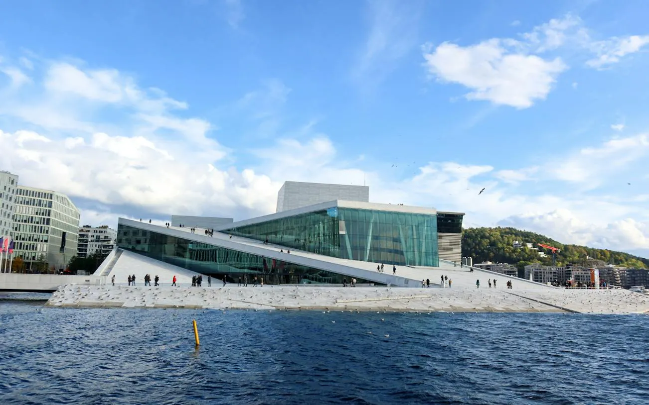 Oslo Opera House with visitors walking on the sloped roof, Oslo Walking Tour.