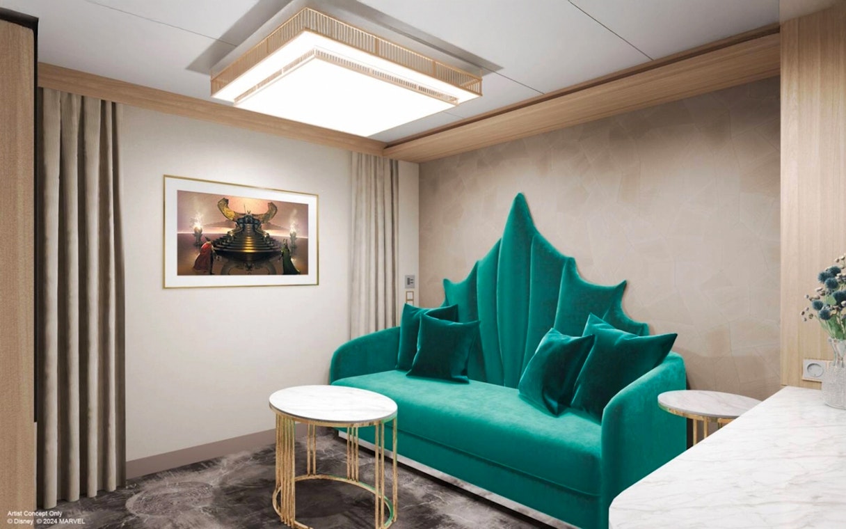 Concierge family stateroom with teal sofa and artwork, Disney Adventure Cruise.