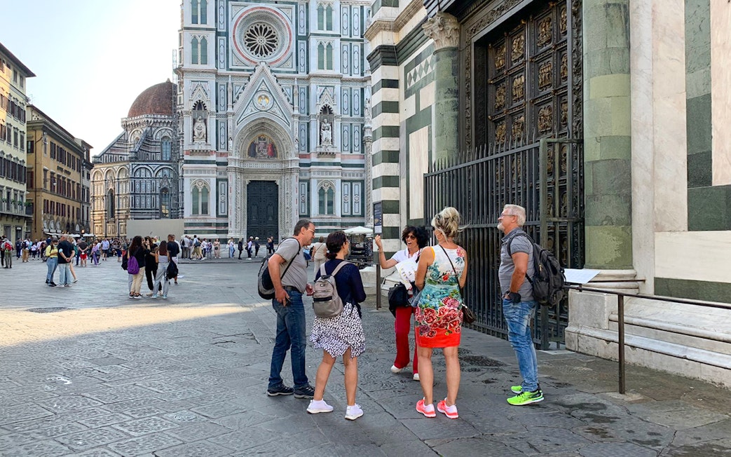 Tour group with guide outside Duomo Florence, Italy.