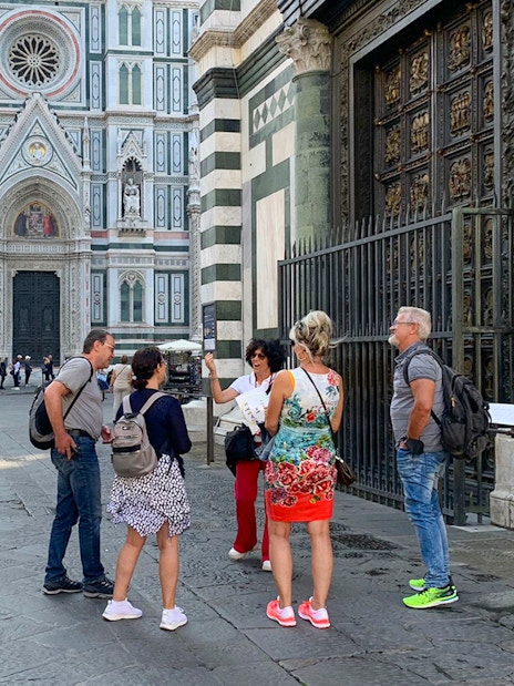 Tour group with guide outside Duomo Florence, Italy.