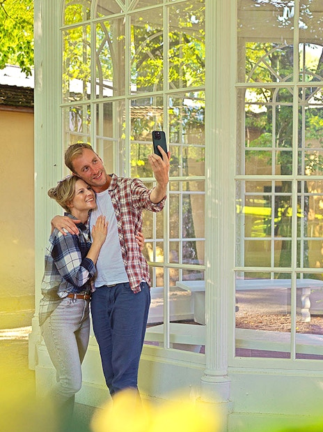 Couple taking a selfie at the gazebo from The Sound of Music tour in Salzburg.