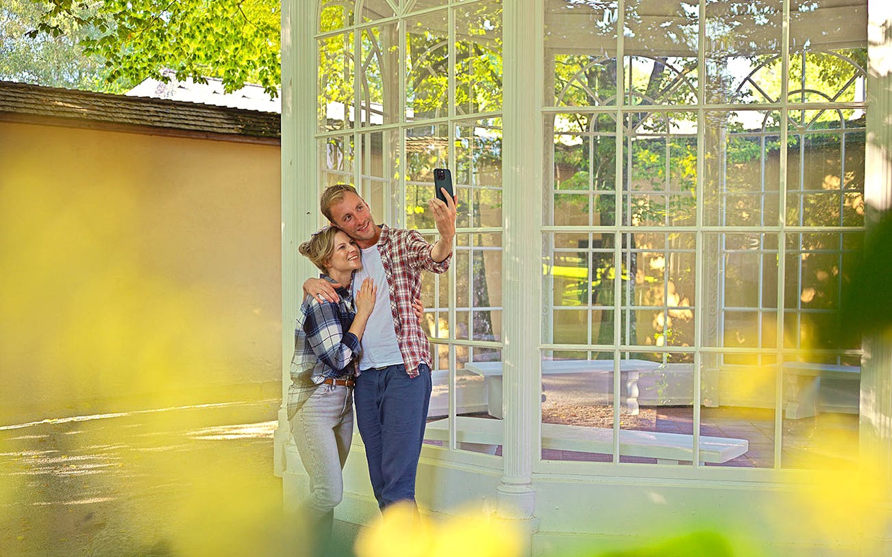Couple taking a selfie at the gazebo from The Sound of Music tour in Salzburg.
