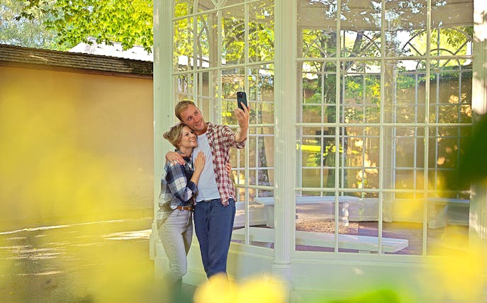 Couple taking a selfie at the gazebo from The Sound of Music tour in Salzburg.