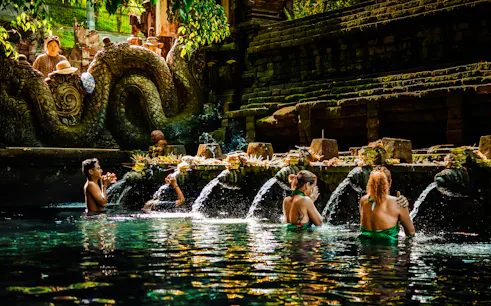Visitors participating in water purification ritual at Tirta Empul Temple, Bali.