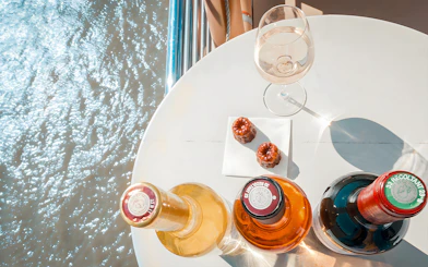 Bottles of wine and canelés on a table during Bordeaux River Cruise.