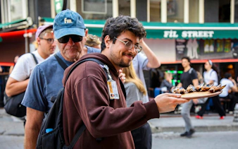 Street vendor offering stuffed mussels on Istanbul food tour.