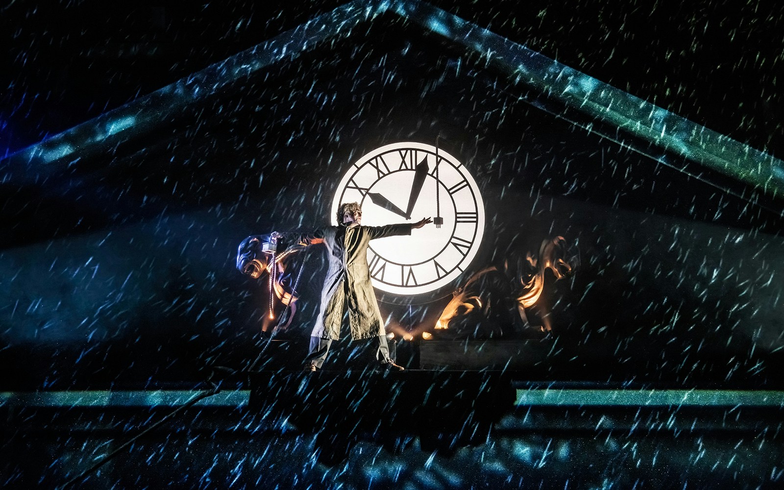 Performer on stage with clock backdrop in Back to the Future the Musical.