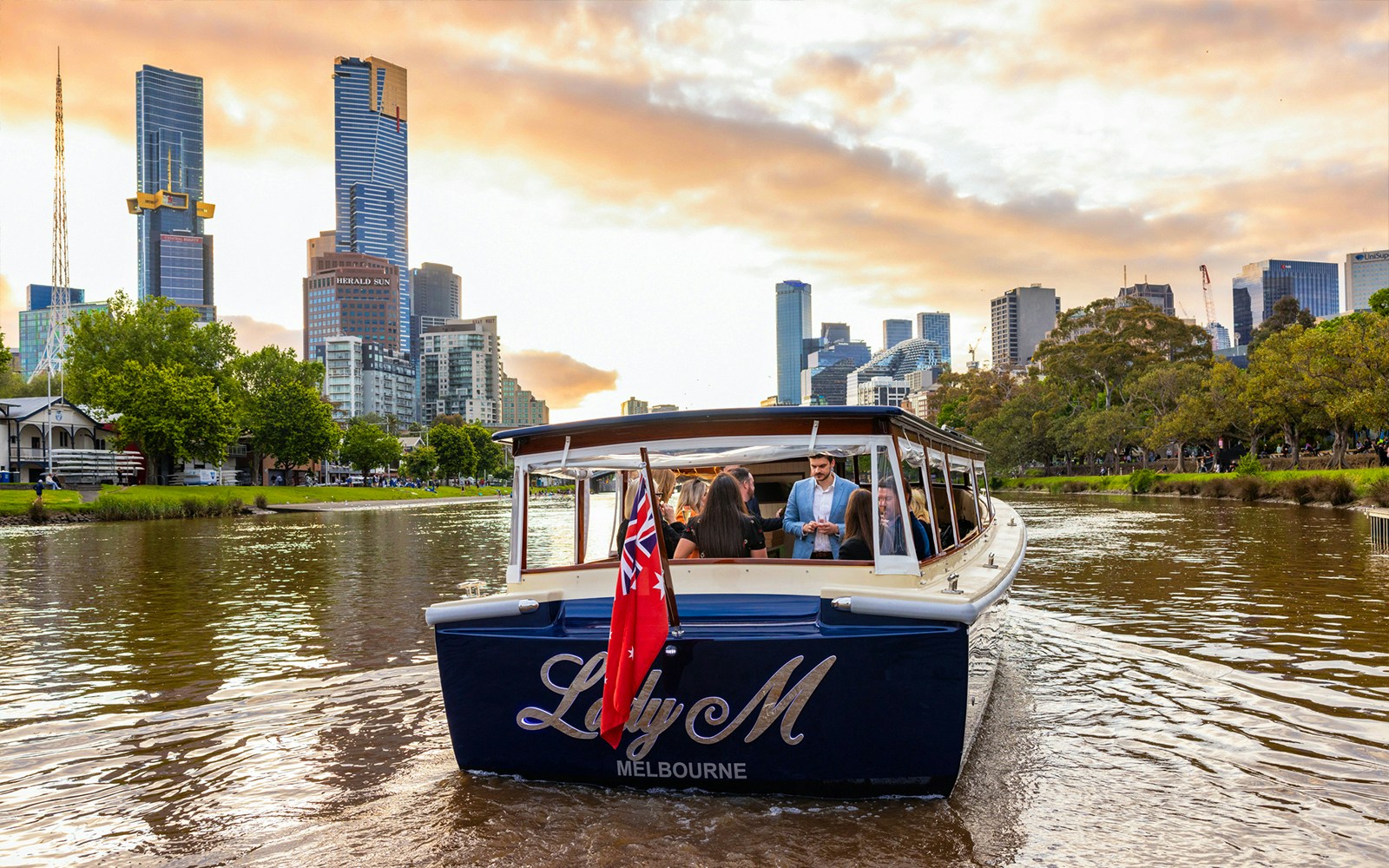 Yarra River sunset cruise with city skyline view, Melbourne.