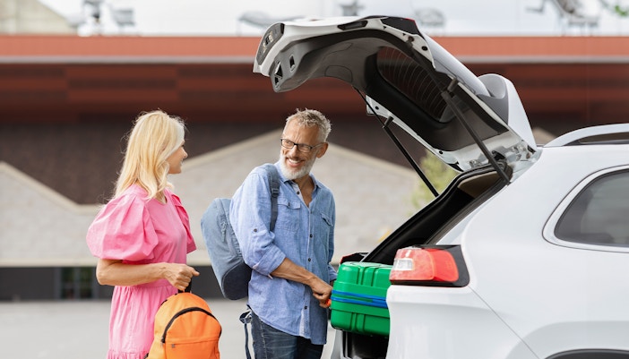 Couple getting in private airport transfer car, Bangkok
