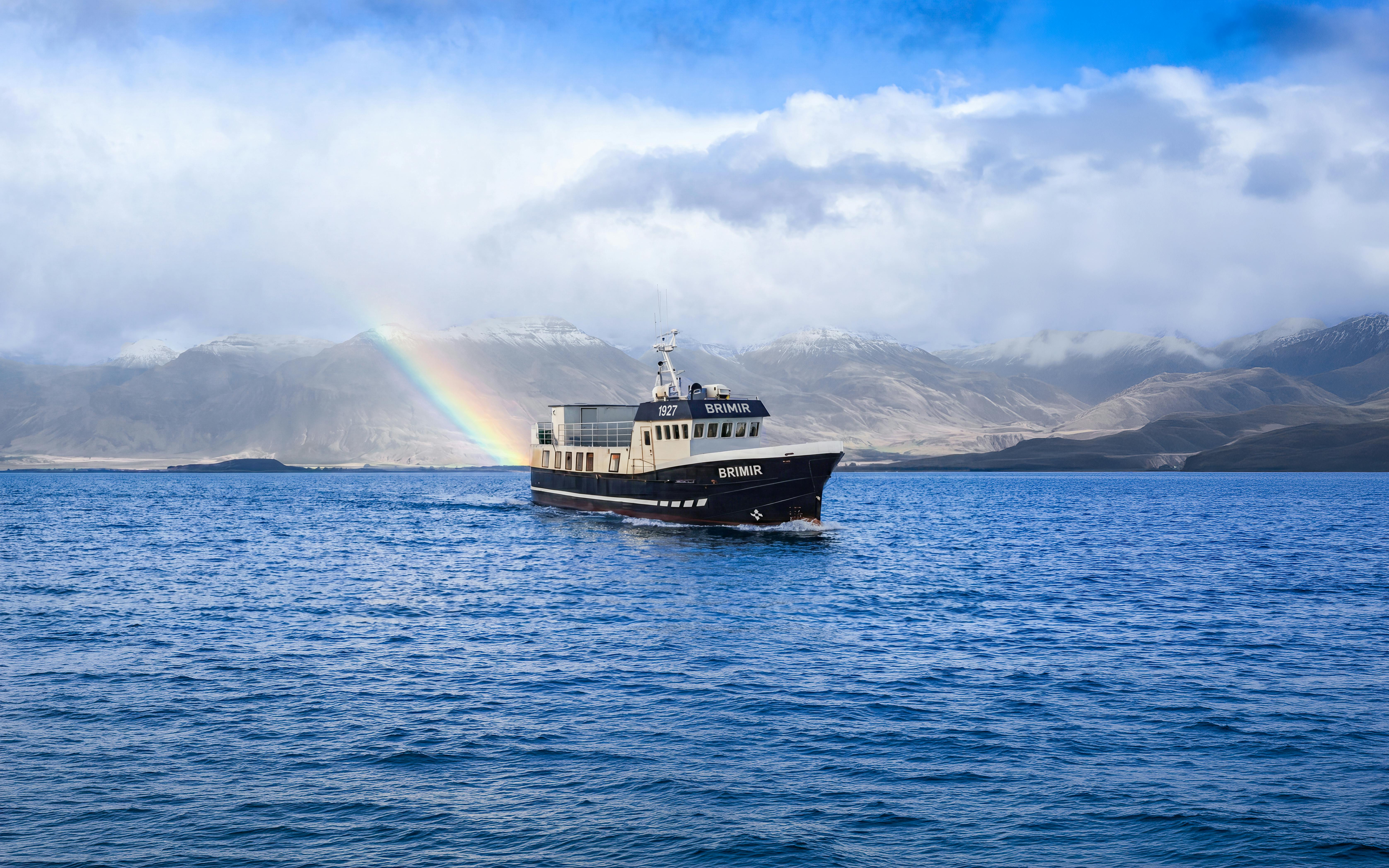 Boat on Eyjafjörður with rainbow, Akureyri whale watching tour.