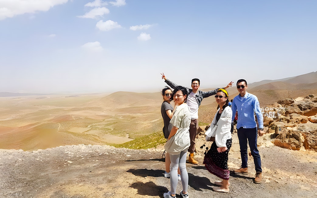 Group posing in Agafay Desert, Marrakech with expansive desert landscape.