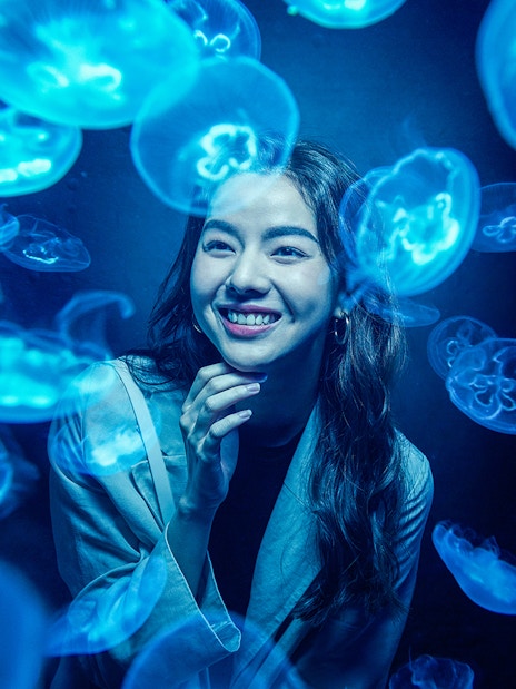 Woman observing jellyfish at S.E.A. Aquarium Singapore.