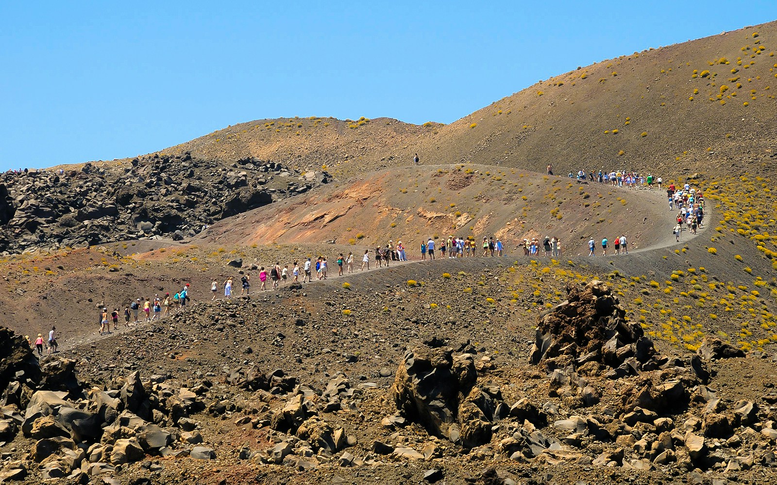 Nea Kameni volcano with cruise ship in Santorini's volcanic islands.
