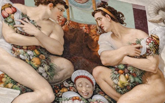 Fresco detail in Palazzo Vecchio depicting figures with fruit garlands, part of Medici Power Story tour.
