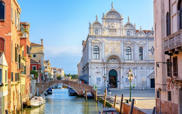Venice canal with historic buildings and bridge on a 2-hour walking tour.