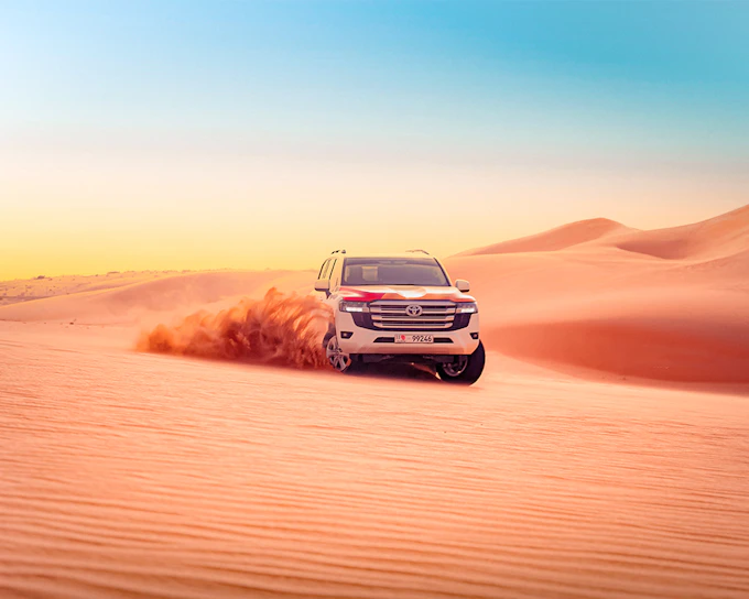 Abu Dhabi Evening Desert Safari with 4x4 Dune Bashing, Camel Ride, & BBQ Dinner