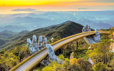 Golden Bridge held by giant hands at Sun World Ba Na Hills, Da Nang, Vietnam.