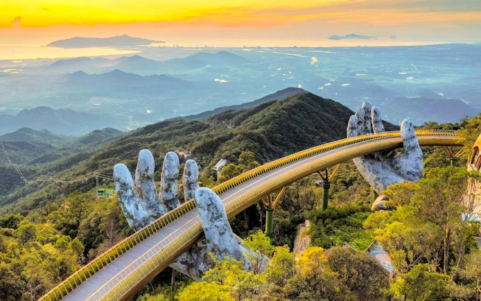 Golden Bridge held by giant hands at Sun World Ba Na Hills, Da Nang, Vietnam.