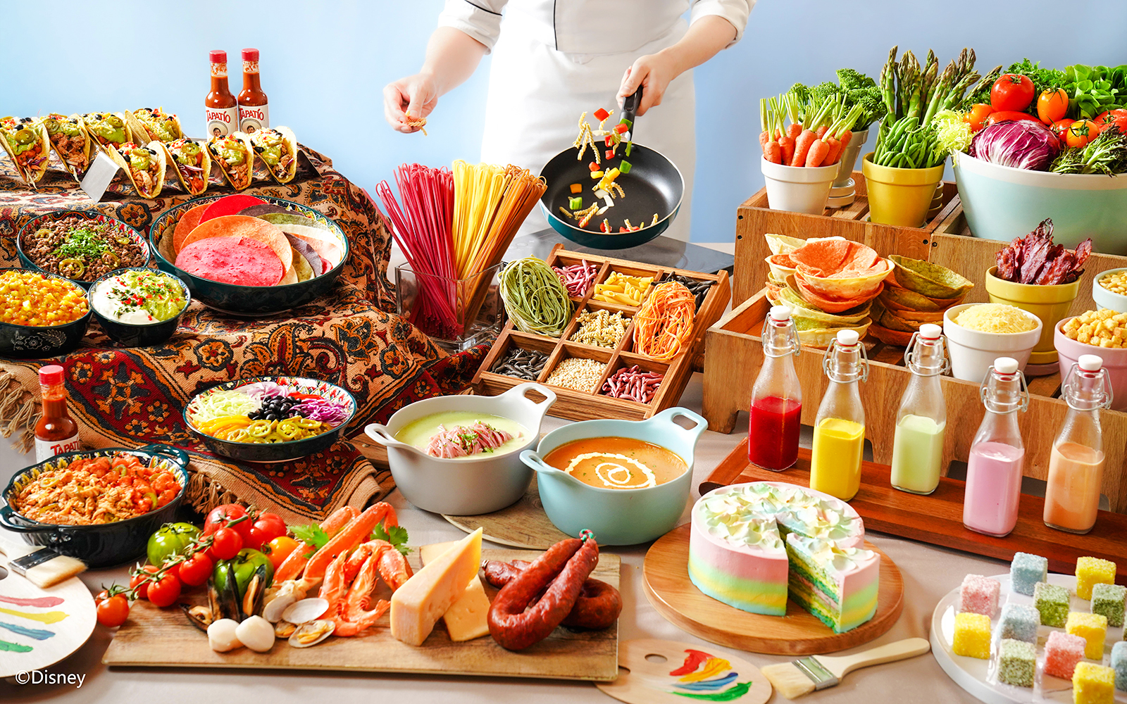 Buffet spread with tacos, colorful pasta, fresh vegetables, and desserts at Disneyland Hong Kong.