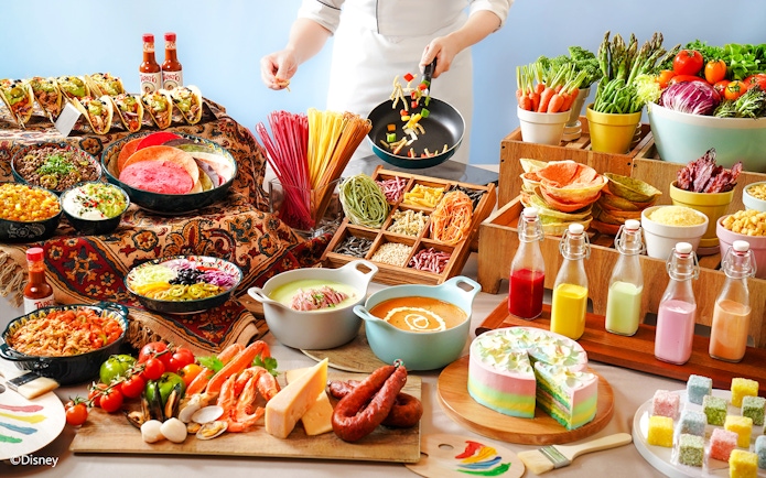 Buffet spread with tacos, colorful pasta, fresh vegetables, and desserts at Disneyland Hong Kong.