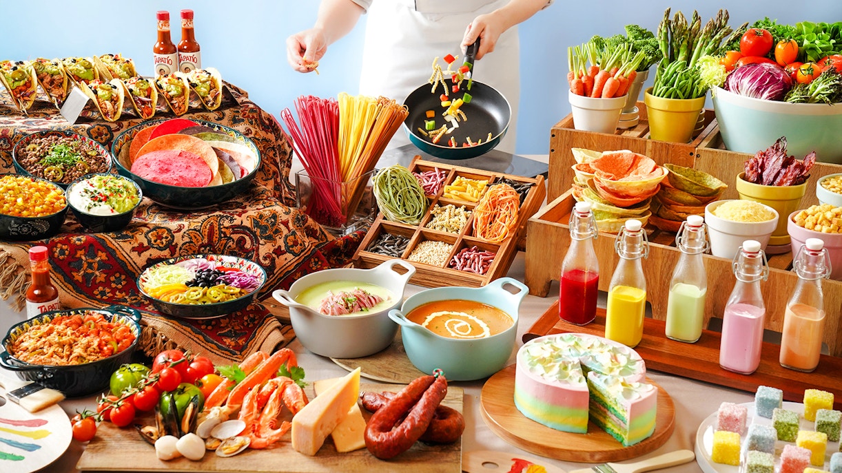 Buffet spread with tacos, colorful pasta, fresh vegetables, and desserts at Disneyland Hong Kong.