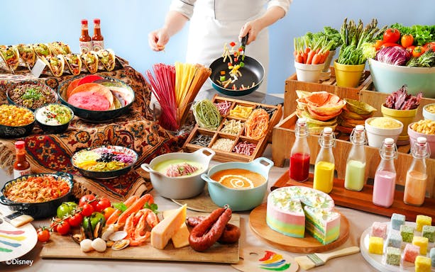 Buffet spread with tacos, colorful pasta, fresh vegetables, and desserts at Disneyland Hong Kong.
