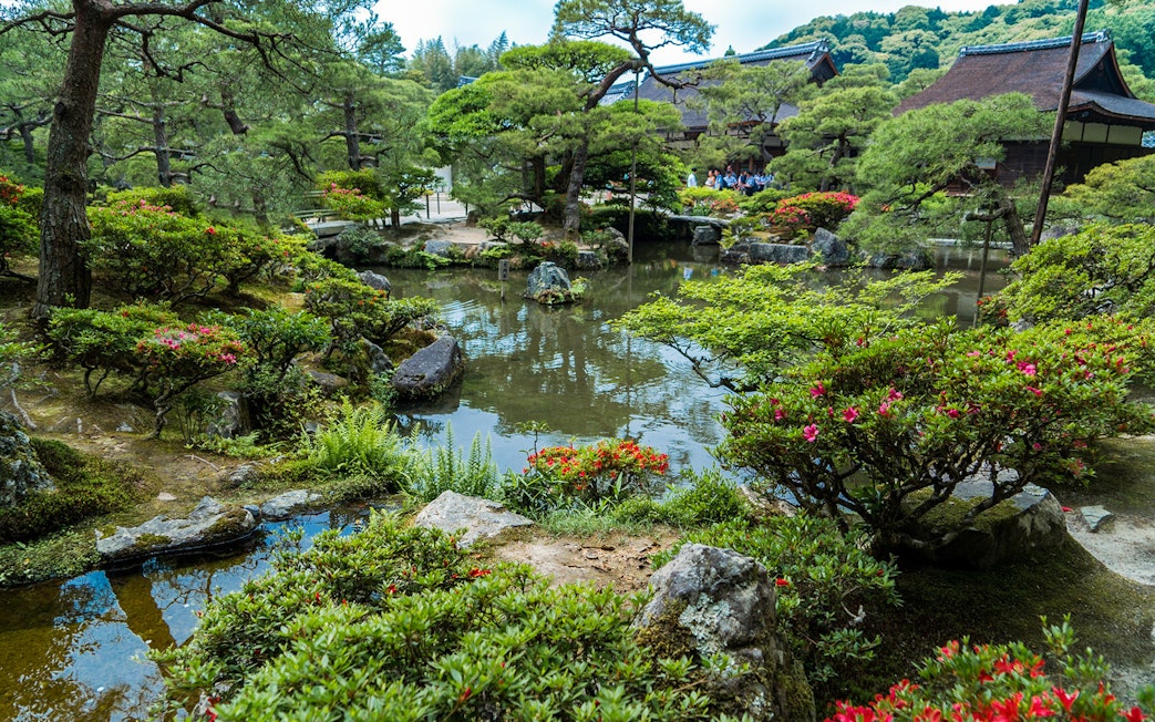 Nijo Castle garden with pond and traditional Japanese architecture in Kyoto.