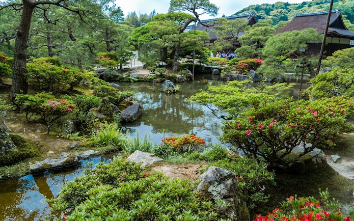 Nijo Castle garden with pond and traditional Japanese architecture in Kyoto.
