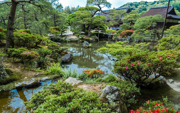 Nijo Castle garden with pond and traditional Japanese architecture in Kyoto.