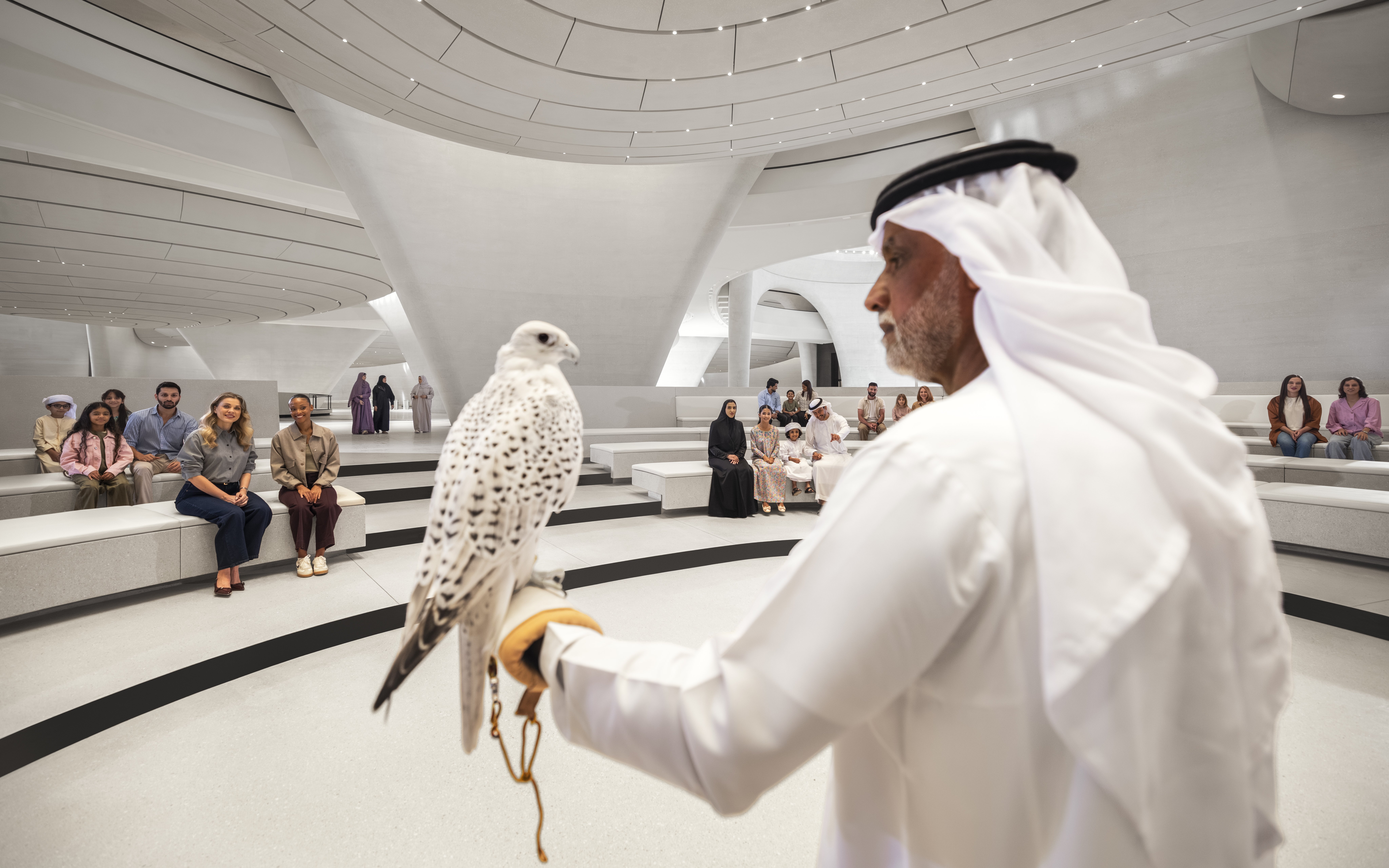 Bird show at Zayed National Museum, Abu Dhabi with audience seated in modern amphitheater.