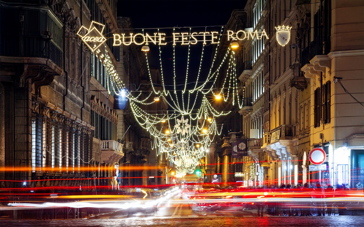 Christmas lights on a street in Rome during a holiday bus tour.