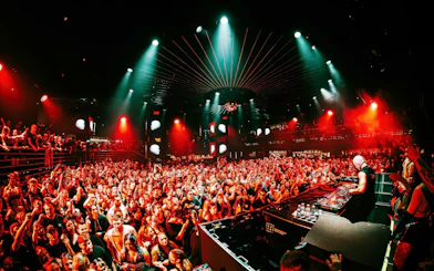 DJ performing at EPIC Club Prague after party with vibrant crowd and lights.