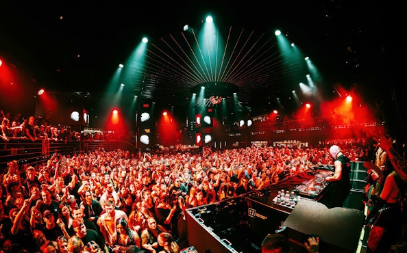 DJ performing at EPIC Club Prague after party with vibrant crowd and lights.